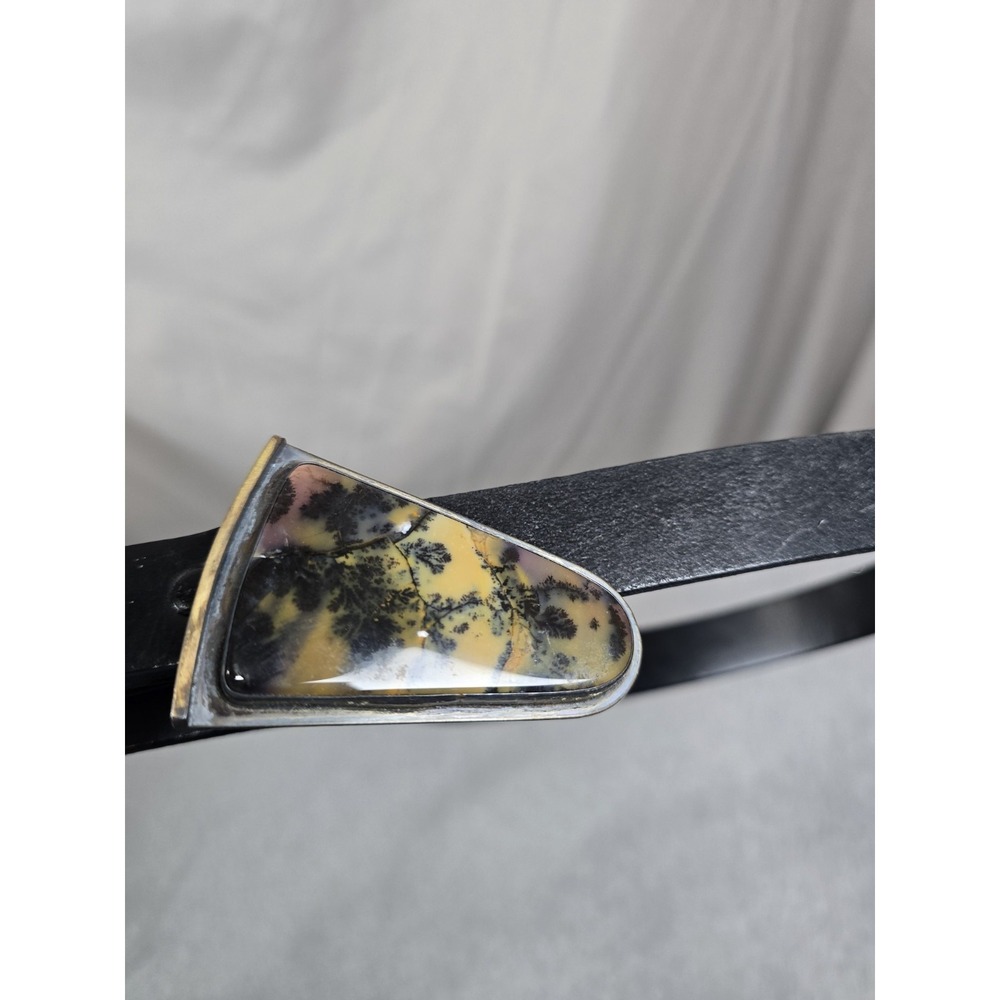 handmade belt buckle is crafted from sterling silver with 14K gold accents...